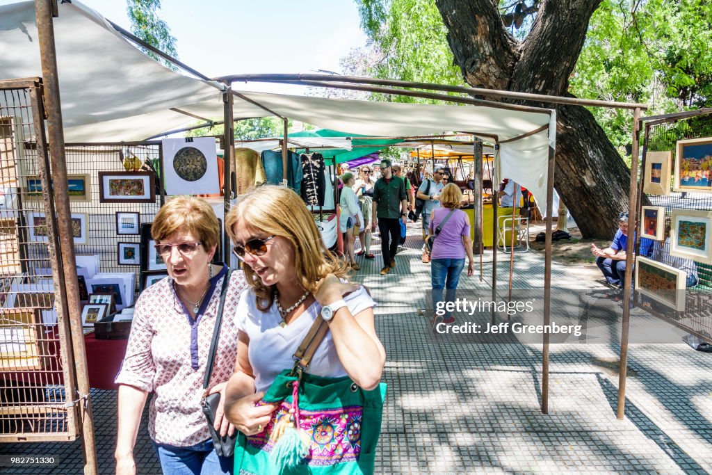 Women looking at art prints at the Craft Fair at Plaza Francia Feria, Artisanal Plaza Francia.