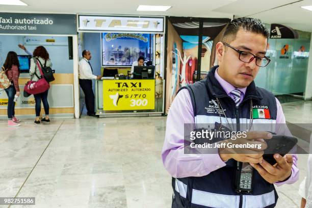 Mexico City, Airport ground transportation, service agent using smartphone.