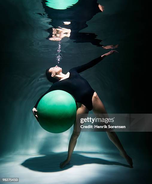 female gymnast with exercise ball underwater - swimwear singlet stock pictures, royalty-free photos & images