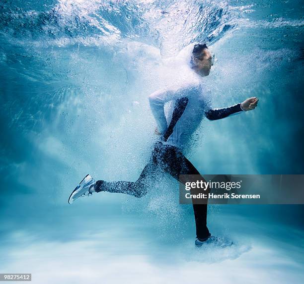 male jogger running underwater - crazy pool foto e immagini stock