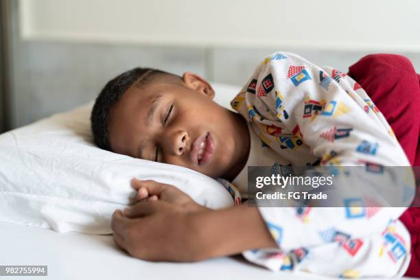 kid waking up - boy asleep in bed stock pictures, royalty-free photos & images