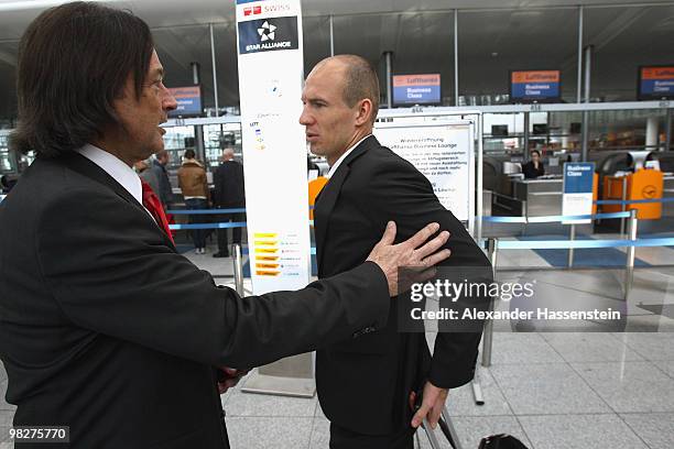 Bayern Munich's player Arjen Robben talks to his team doctor Hans-Wilhelm Mueller-Wohlfahrt prior to their departure at the Munich Airport on April...