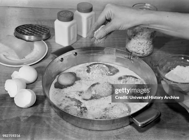 Woman Sprinkling Grated Cheese while Making Baked Eggs with Cheese, A Meat Substitute, Ann Rosener for Office of War Information, October 1942.
