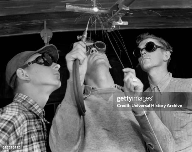 Instructor Training Two Young Men to Weld Aircraft at Vocational School as part of Program to Provide more Workers for War Production for Florida's...
