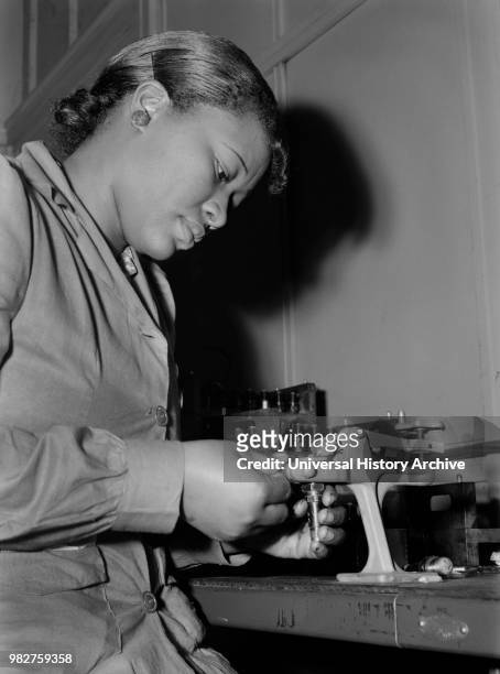 Mignon Gunn, Female Factory Worker, Reconditioning used Spark Plugs to be re-used in Testing Military Aircraft Motors at Buick Plant Converted for...