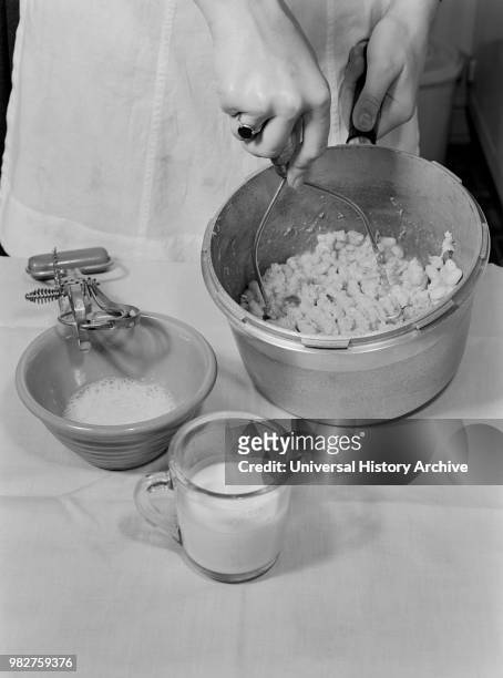 Woman Mashing Cooked Beans while Making Baked Bean Loaf, a Nourishing and Healthy Meat Substitute, Ann Rosener for Office of War Information, October...