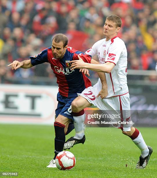 Rodrigo Palacio of Genoa CFC battles for the ball against Jurgen Prutsch of AS Livorno Calcio during the Serie A match between Genoa CFC and AS...