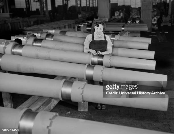 Mrs. Mary Betchner Inspecting 105mm Howitzer Artillery on Assembly Line, Chain Belt Company, Milwaukee, Wisconsin, USA, Howard R. Hollem for Office...