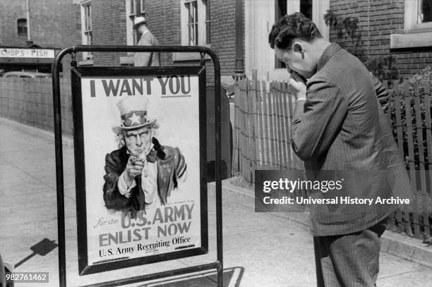 Man Looking at U.S. Army Recruitment Sign, Benton Harbor, Michigan, USA, John Vachon for Farm Security Administration July 1940.