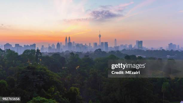 city skyline at sunrise, kuala lumpur, malaysia - kuala lumpur aerial view stock pictures, royalty-free photos & images