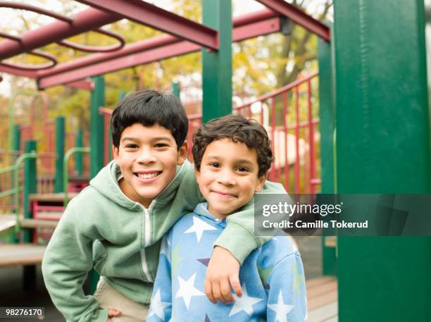 brothers in playground. - brothers boys cuddle stock pictures, royalty-free photos & images