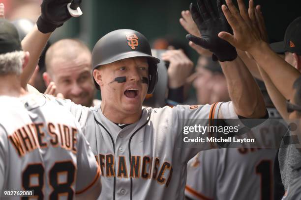 Nick Hundley of the San Francisco Giants celebrates hitting a home run during a baseball game against the Washington Nationals at Nationals Park on...