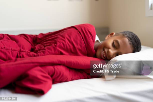 kid waking up - boy asleep in bed stock pictures, royalty-free photos & images