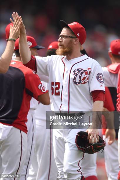 Sean Doolittle of the Washington Nationals celebrates a win after a baseball game against the San Francisco Giants at Nationals Park on June 20, 2018...