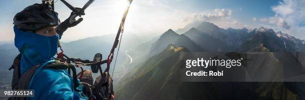 paragliding over mountains, slovenia - paragliding stock pictures, royalty-free photos & images