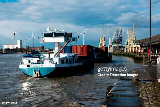 Container barge approaches dock in Antwerp, Belgium.