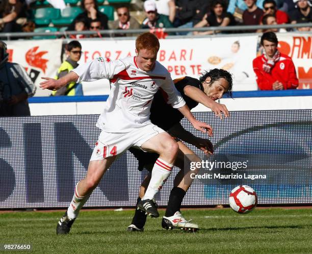 Alessandro Gazzi oa AS Bari battles for the ball with Luca Toni of AS Roma during the Serie A match between AS Bari and AS Roma at Stadio San Nicola...