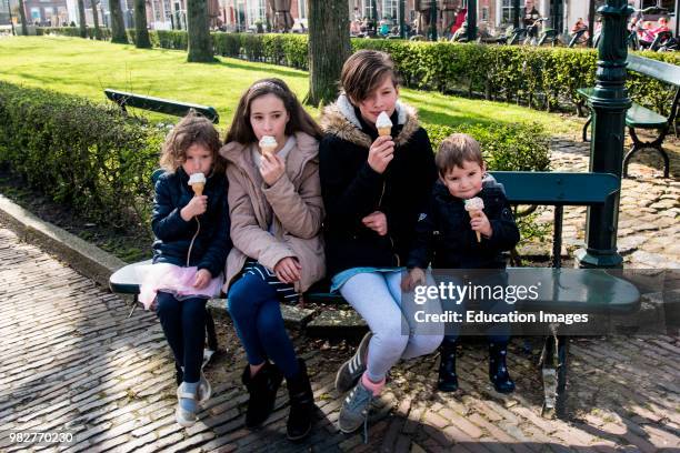 Three girls and a boy eating ice cream cones iin Veere, Netherlands.