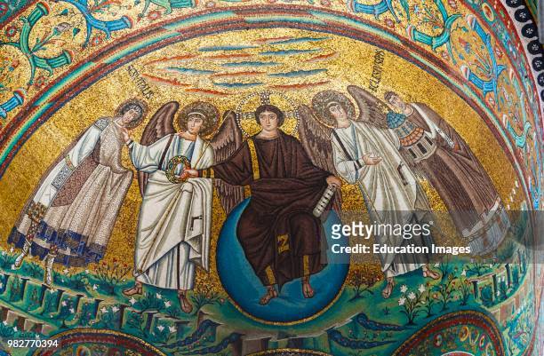 Ravenna, Ravenna Province, Italy. Mosaic in San Vitale basilica. Christ, seated on an orb representing the world, offers the crown of martyrdom to...