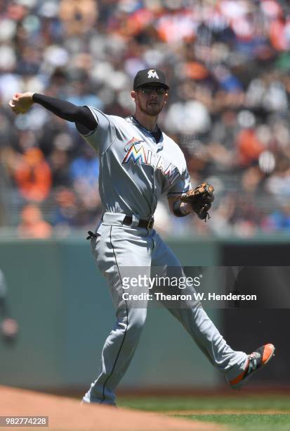 Riddle of the Miami Marlins throws off balance to first base throwing out Mac Williamson of the San Francisco Giants in the bottom of the fourth...