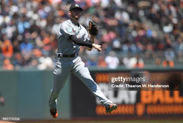 Riddle of the Miami Marlins throws off balance to first base throwing out Mac Williamson of the San Francisco Giants in the bottom of the fourth...