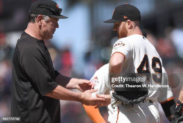 Manager Bruce Bochy of the San Francisco Giants takes the ball from pitcher Sam Dyson taking Dyson out of the game against the Miami Marlins in the...