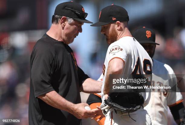 Manager Bruce Bochy of the San Francisco Giants takes the ball from pitcher Sam Dyson taking Dyson out of the game against the Miami Marlins in the...