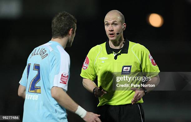 Referee Anthony Taylor talks to Ryan Gilligan of Northampton Town during the Coca Cola League Two Match between Grimsby Town and Northampton Town at...