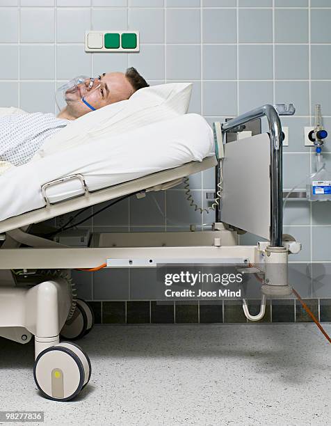 male patient with oxygen mask  - stretcher stock-fotos und bilder