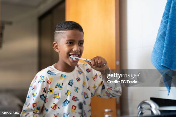 little cut kid brushing teeth - human teeth stock pictures, royalty-free photos & images