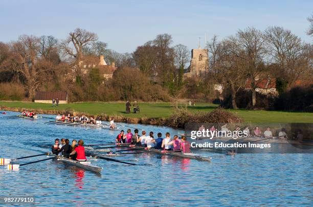 Rowers with cox on the river Cam at village of Fen Ditton near Cambridge, England.