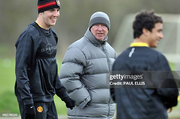 Manchester United manager Sir Alex Ferguson talks to Irish defender John O'Shea during a training session at their Carrington training ground in...