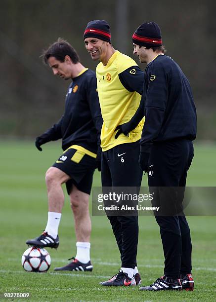 Rio ferdinand and Dimitar Berbatov of Manchester United look on during a training session ahead of their Champions League match against Bayern Munich...