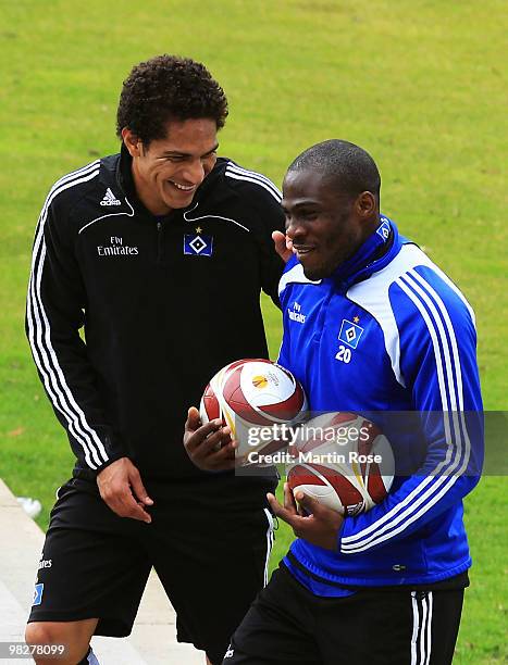 Paolo Guerrero jokes with team mate Guy Demel after the Hamburger SV training session at the HSH Nordbank Arena on April 6, 2010 in Hamburg, Germany....