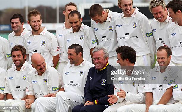 Durham captain Will Smith applauds bowler Stephen Harmison after he arrived late for the team picture during the Durham CCC photocall at the...