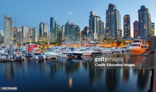 Evening views of city skyline from harbor. Vancouver. British Columbia. Canada.