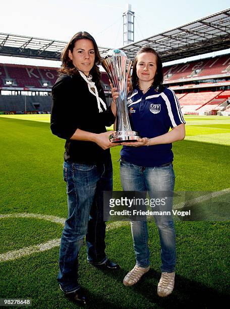 Ursula Holl of FCR 2001 Duisburg and Melanie Groll of FF USV Jena pose with the cup before the DFB press conference of the Women's DFB team on April...