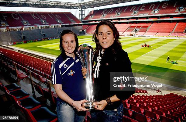 Ursula Holl of FCR 2001 Duisburg and Melanie Groll of FF USV Jena pose with the cup before the DFB press conference of the Women's DFB team on April...