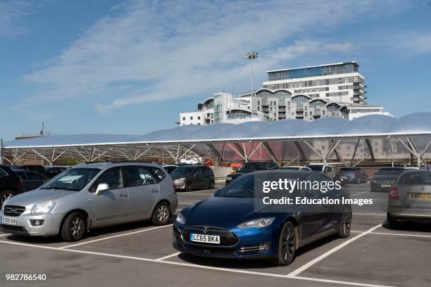 Basingstoke, Hampshire, England, UK. Apartments and office buildings seen above a multistory car park in Basingstoke town center.