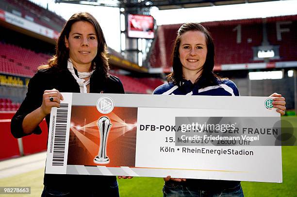 Ursula Holl of FCR 2001 Duisburg and Melanie Groll of FF USV Jena pose with an enlarged ticket for the Women's DFB Cup Final 2010 before the Women's...