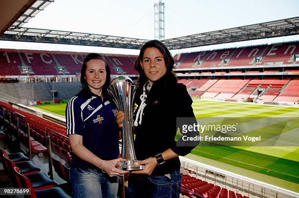 Ursula Holl of FCR 2001 Duisburg and Melanie Groll of FF USV Jena pose with the trophy before the Women's DFB press conference on April 6, 2010 in...