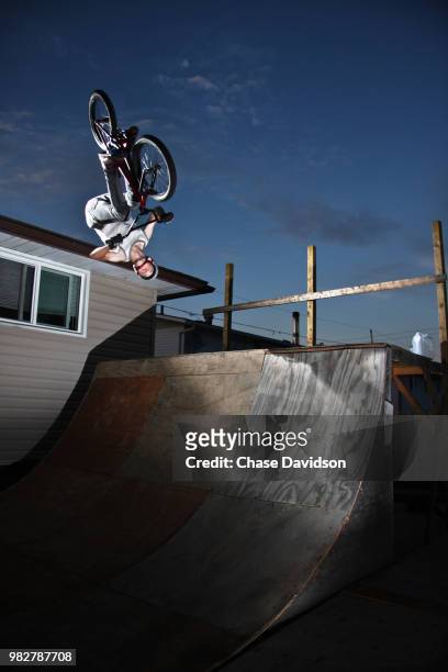 bmx biker performing backflip on ramp, greater sudbury, ontario, canada - greater sudbury canada stock pictures, royalty-free photos & images