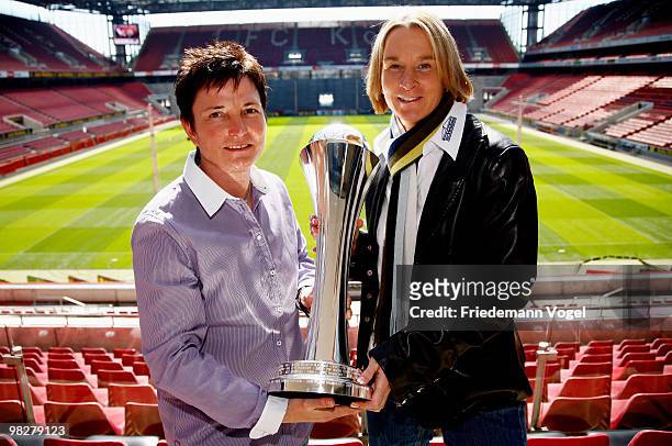 Head coach Martina Voss-Tecklenburg of FCR 2001 Duisburg and head coach Heidi Vater of FF USV Jena pose with the trophy before the DFB press...