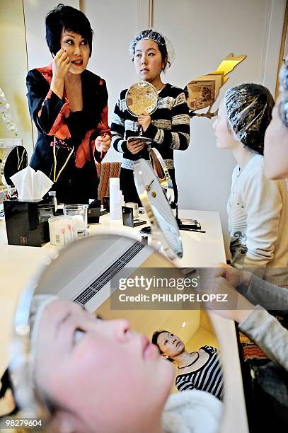 Chinese cosmetics pioneer Yue-Sai Kan trains volunteers for Shanghai's 2010 World Expo during a makeup session in Shanghai on April 6, 2010. After...
