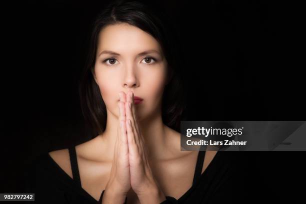 spiritual young woman praying - invocation stock pictures, royalty-free photos & images