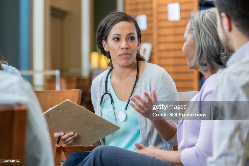 Female doctor explains something to patients