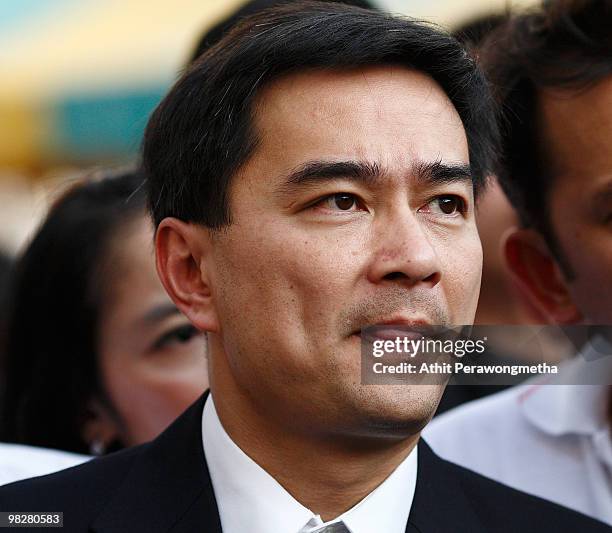 Thai Prime Minister Abhisit Vejjajiva bites his lip after inspecting the damage of a police truck caused by grenade explosion at Democrat Party...