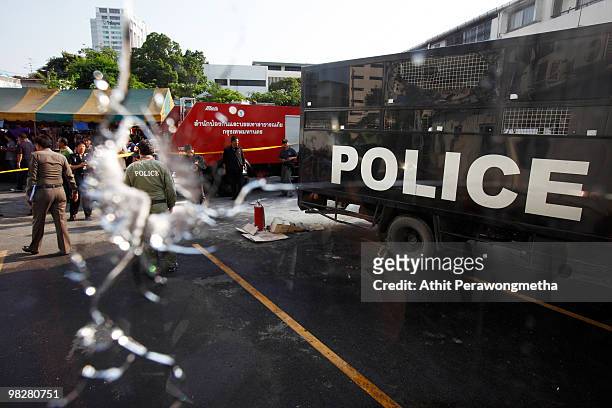 Policemen inspect the damage to a police truck caused by a grenade explosion at Democrat Party Headquarters on April 6, 2010 in Bangkok,Thailand. The...