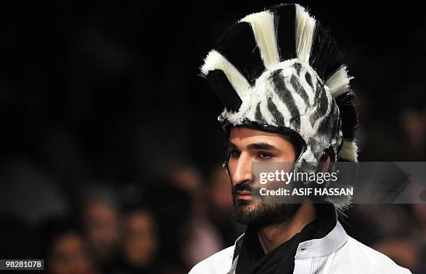 Pakistani ents a creation by Shakeel Saigal during a Fashion Week in Karachi on April 5, 2010. Pakistan began a new fashion week with an opulent...