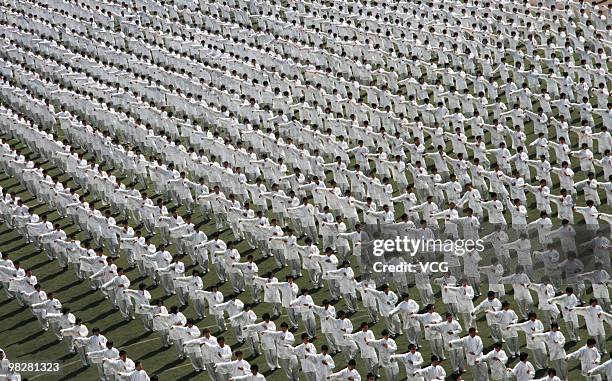 Students perform Tai Chi during a contest at the fifth School of Licheng on April 6, 2010 in Jinan, Shandong province of China.